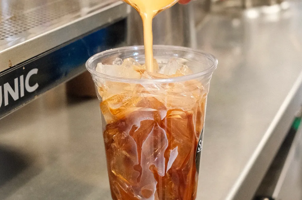 Espresso being poured over ice into a Sorrento's Coffee cup