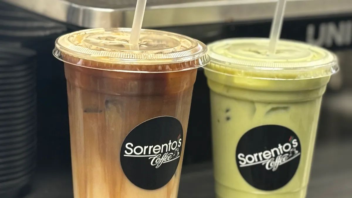 Two iced drinks in Sorrento's Coffee cups, one coffee-colored and one matcha green
